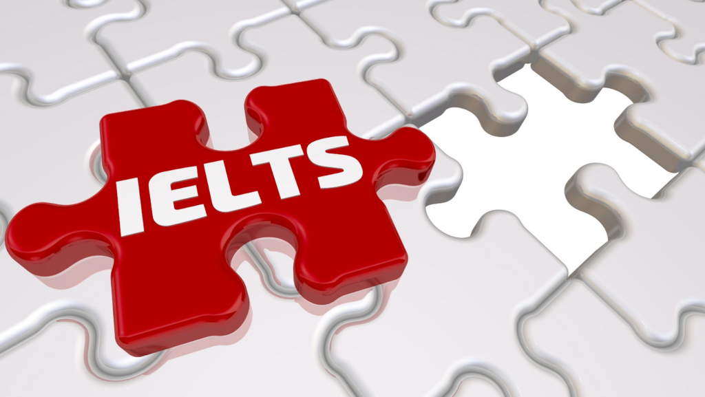 Plain white jigsaw puzzles with one red puzzle piece with IELTS written on it.