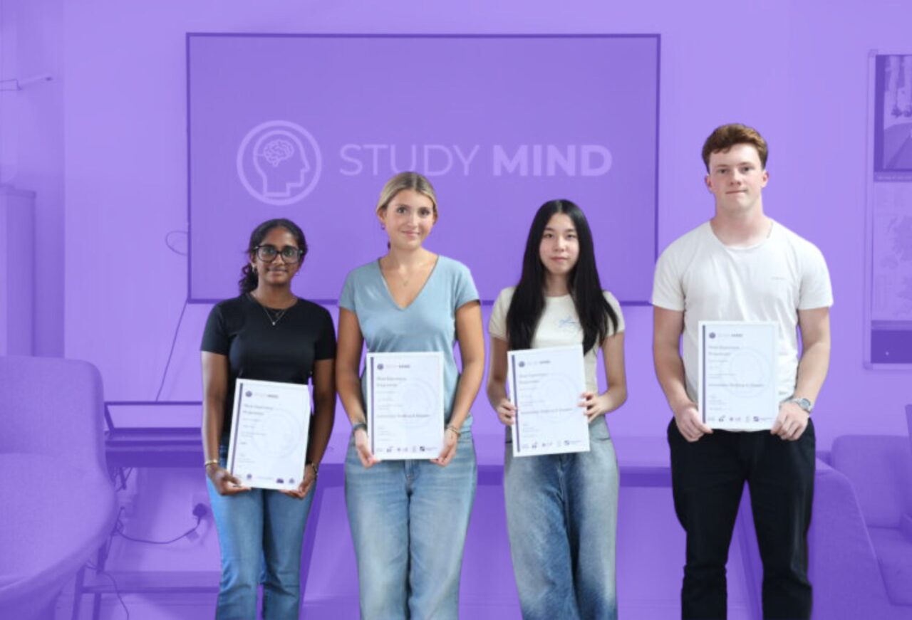 Students holding certificates after completing a biology summer camp programme and celebrating their achievement.