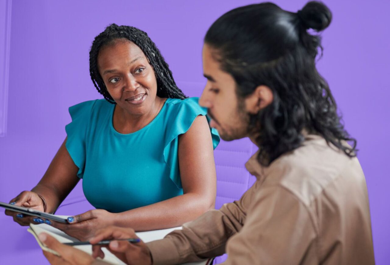 Mentor guiding a student through business concepts during a one-on-one entrepreneurship camp session