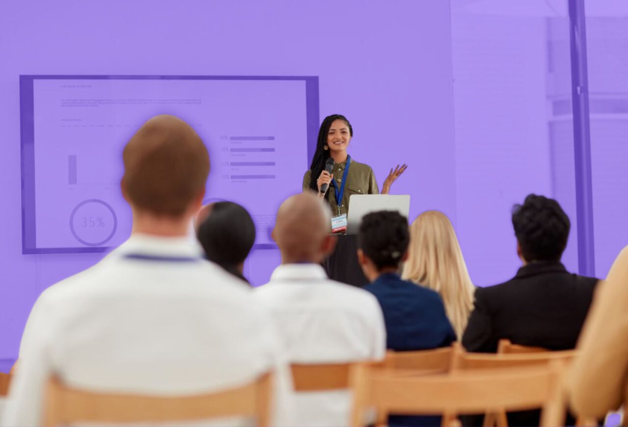 Student delivering a business pitch presentation to an audience during an entrepreneurship career camp