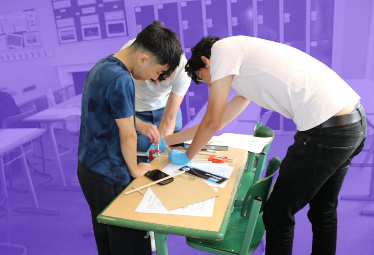 Students collaborating on an engineering design challenge, building and testing prototypes while solving real-world engineering problems.